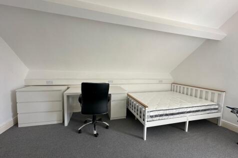 Bright and tidy double bedroom featuring a whit...