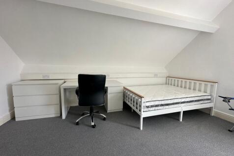 A bright and tidy double bedroom featuring a wh...