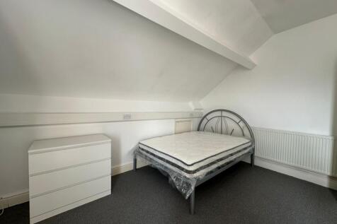A tidy double bedroom featuring a modern metal ...