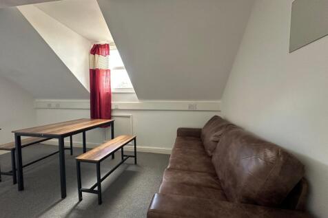 A cozy communal lounge featuring a comfortable ...