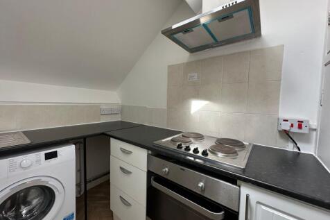 Bright and tidy kitchen featuring modern applia...