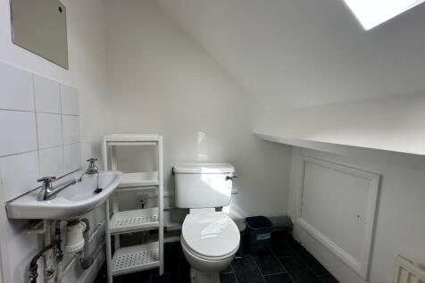 Bright and clean single toilet with modern fixt...