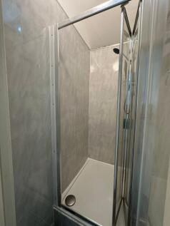 Compact and tidy shower cubicle with glass door...