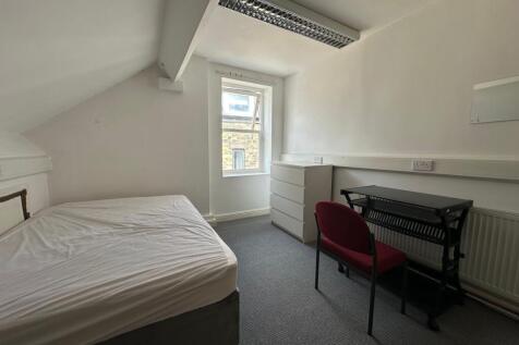 A neat and simple single bedroom featuring a be...