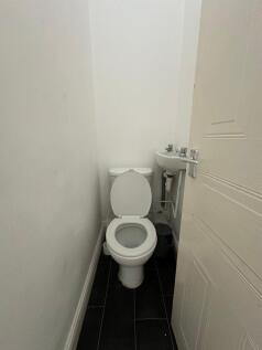 Compact and functional single toilet room featu...