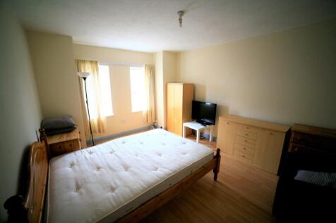 Spacious double bedroom featuring large windows...