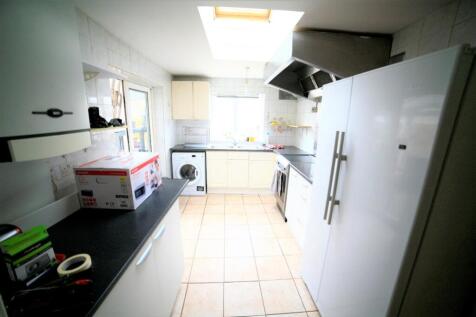 A bright and modern kitchen featuring ample cou...
