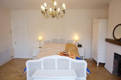 This charming double bedroom features a cozy am...