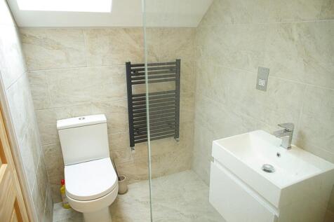 A modern and stylish bathroom featuring elegant...