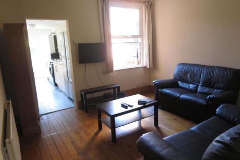 Cozy living room featuring comfortable dark lea...