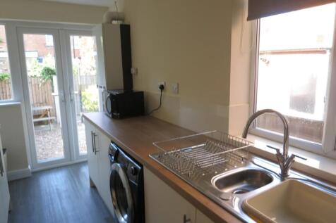 Bright and tidy kitchen featuring modern applia...