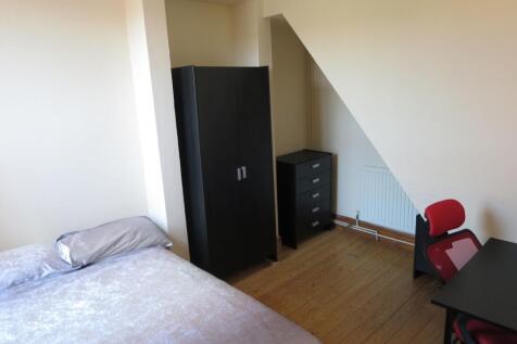 Cozy double bedroom featuring a comfortable bed...