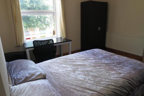 This bright double bedroom features a comfortab...