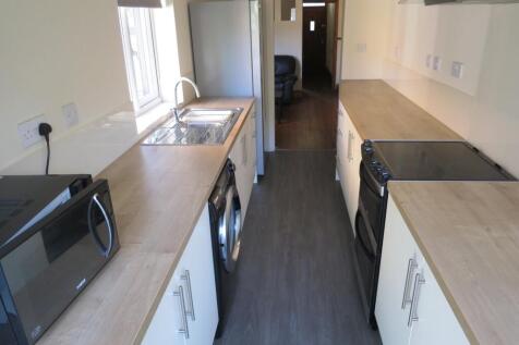 Bright, modern galley kitchen with ample counte...