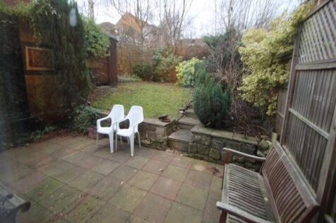 Private rear garden with paved patio, raised la...