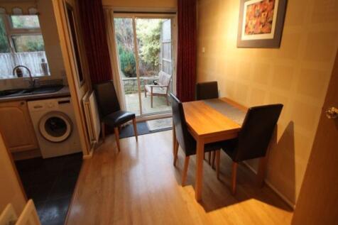 Bright open-plan kitchen/dining area with woode...