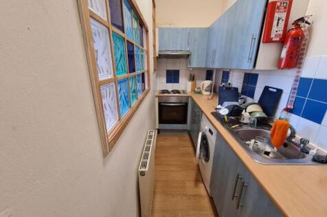 Bright galley-style kitchen with fitted units, ...