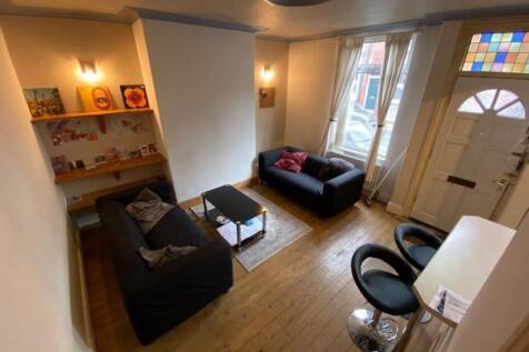 Bright, well-kept living room with two comforta...