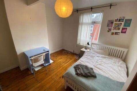 Bright, neatly presented bedroom with a comfort...
