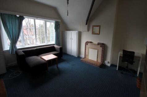 Bright front living room with a large bay windo...