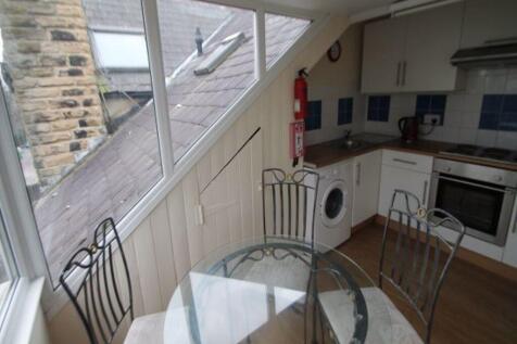 Bright kitchen with sloped windows, built-in ap...