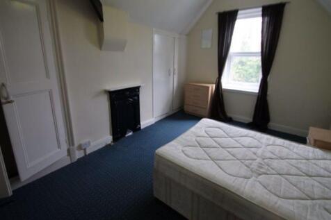 Bright, simply furnished bedroom with a double ...