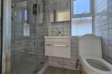 Bright, modern bathroom with a walk-in shower, ...