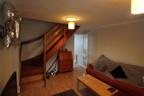Cozy living room with wooden flooring, a comfor...