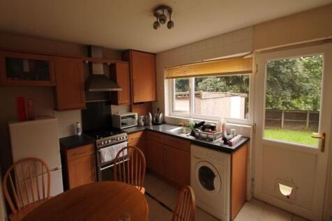 Warm, well-equipped kitchen with wooden cabinet...