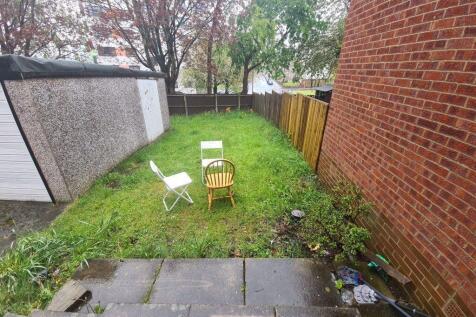 Rear garden with a level lawn, paved patio area...