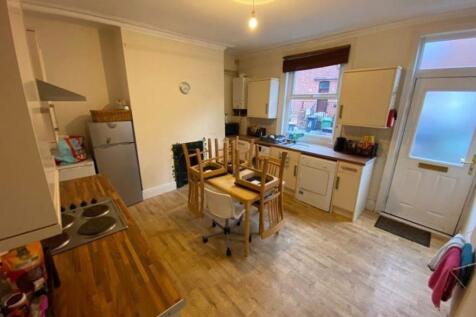 Bright, modern kitchen with wooden worktops, in...