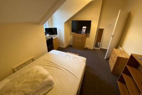 Cozy upstairs single bedroom with sloped ceilin...