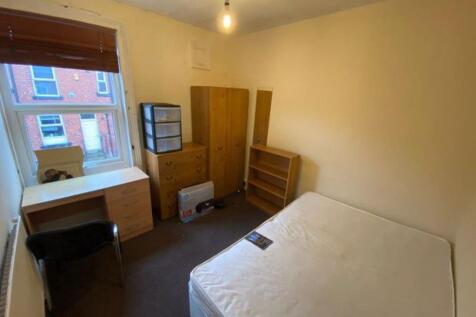 Bright, simply furnished bedroom with a comfort...