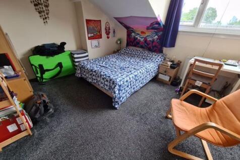 Bright, cozy bedroom with a comfortable double ...