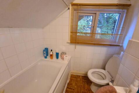 Tidy bathroom with a bathtub, toilet and small ...