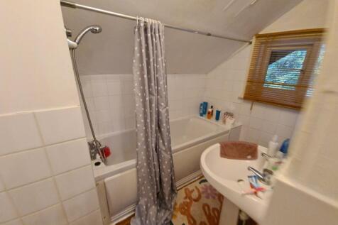 Compact, well-equipped bathroom with a shower-o...