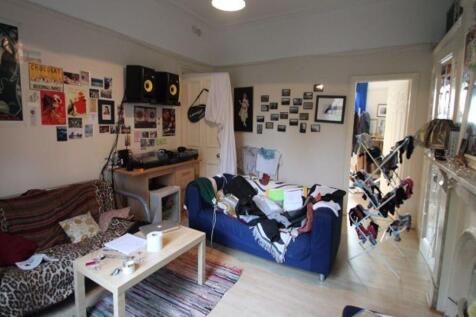 Bright, relaxed communal living room with comfy...