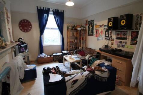 Bright communal living room with a large front ...