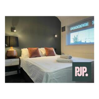 A stylish and inviting double bedroom with ampl...