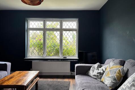 Well-styled living room with a large leaded-win...