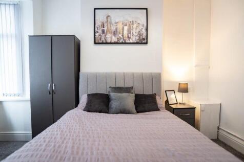 Bright, neatly styled bedroom featuring a doubl...