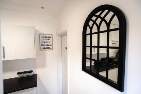 Bright, modern kitchen corner with glossy white...