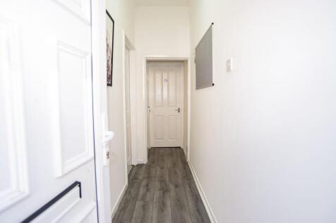 Bright, freshly painted entrance hallway with m...