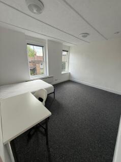 This spacious double bedroom features large win...