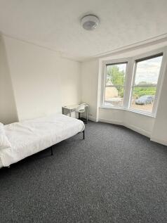 Bright and spacious double bedroom featuring la...