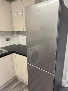 A modern kitchen featuring sleek cabinetry and ...