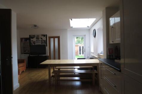 Bright and spacious living room featuring ample...