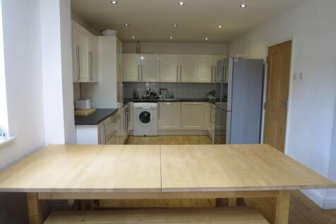 A bright and modern kitchen featuring ample bei...