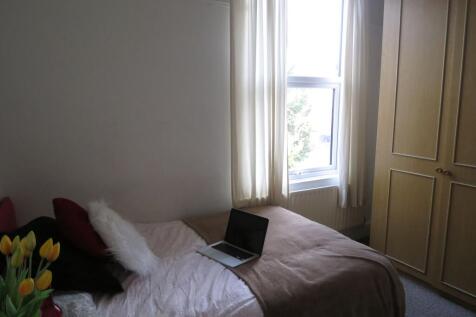 A cozy, well-maintained double bedroom with a c...