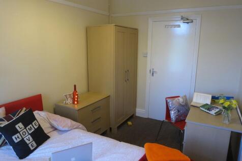 A cozy bedroom with a comfortable bed, a bedsid...